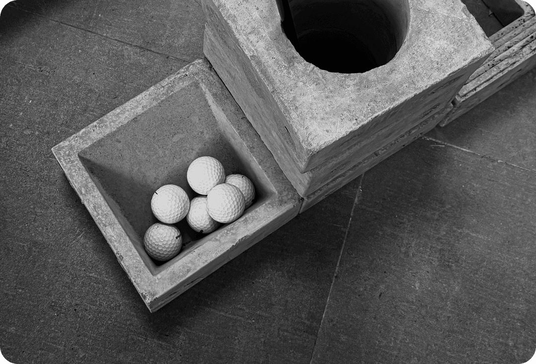 A wooden box of golf balls